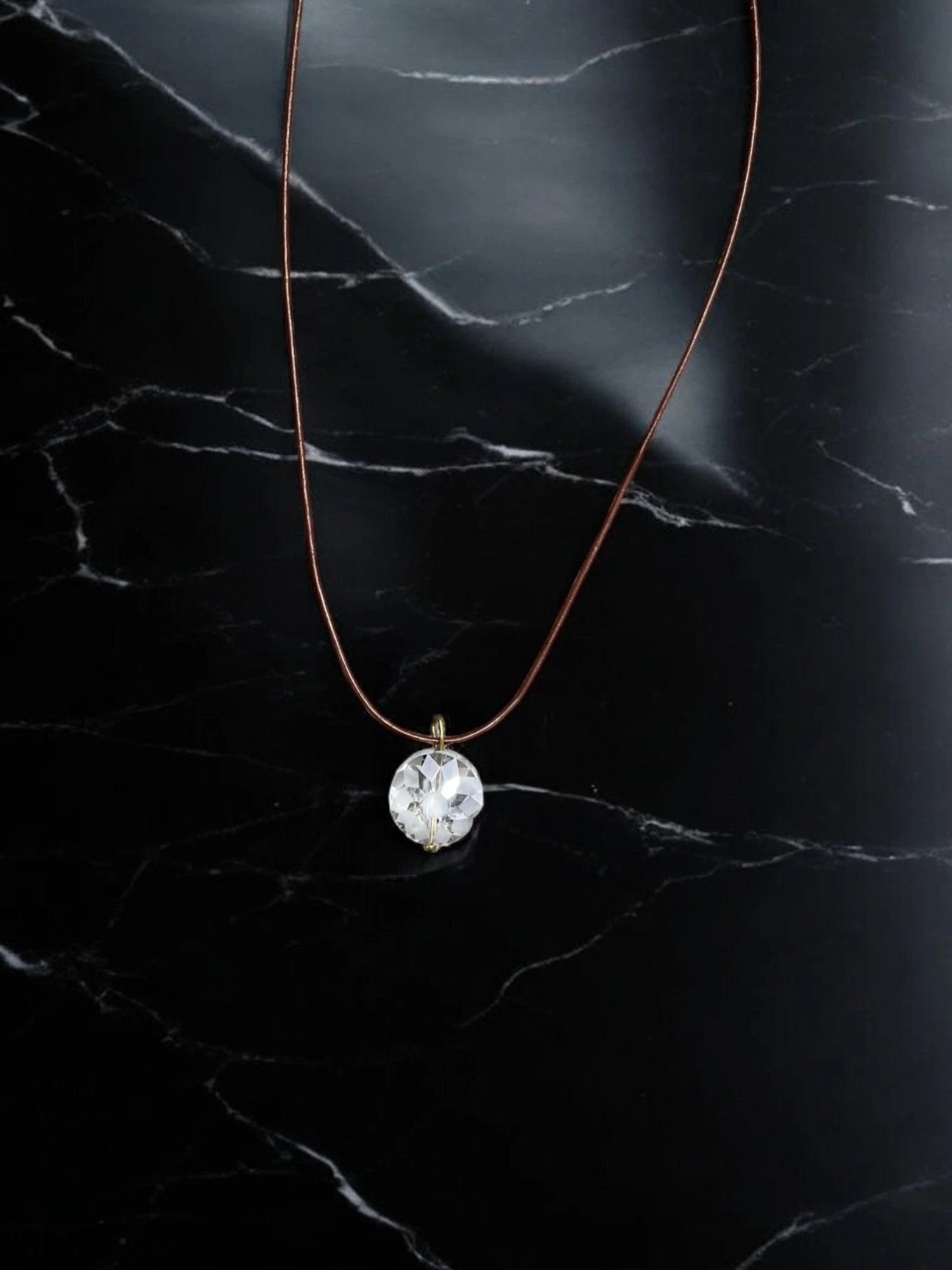 Simple Elegance: Crystal Pendant Necklace on Brown Cord