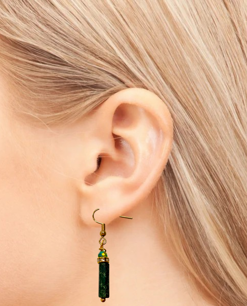 Green beaded earring worn by a person with blonde hair.