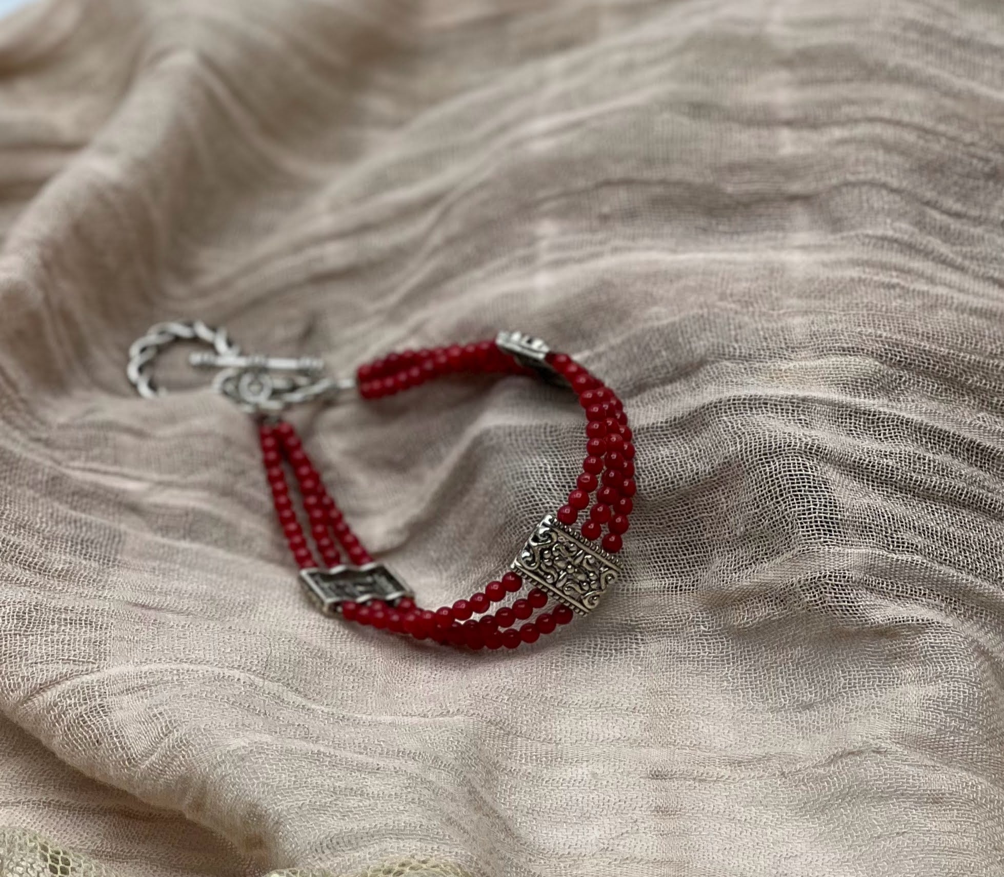 Dazzling Red Jasper Triple Strand Bracelet with Filigree Accents